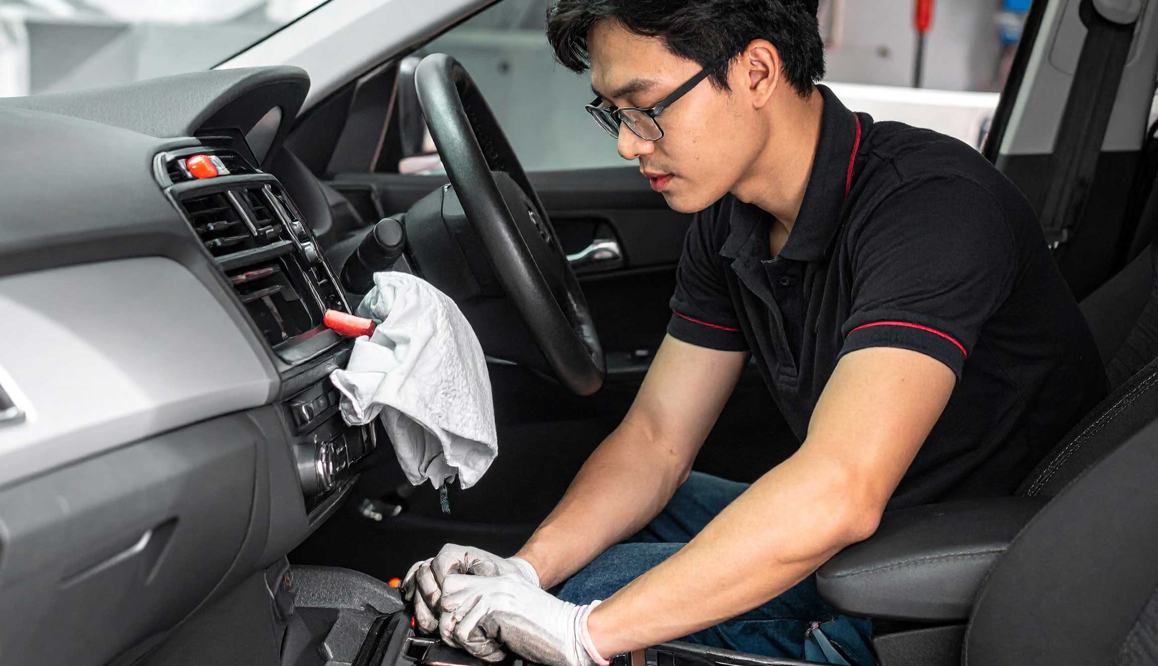mechanic repairing a car's interior with name brand parts